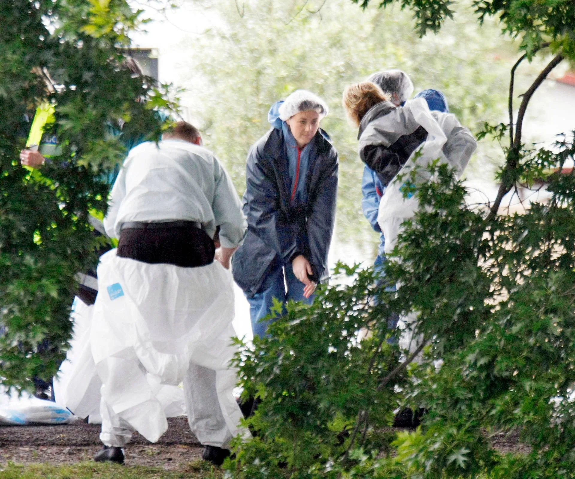 Crime scene investigators tending to the crime site