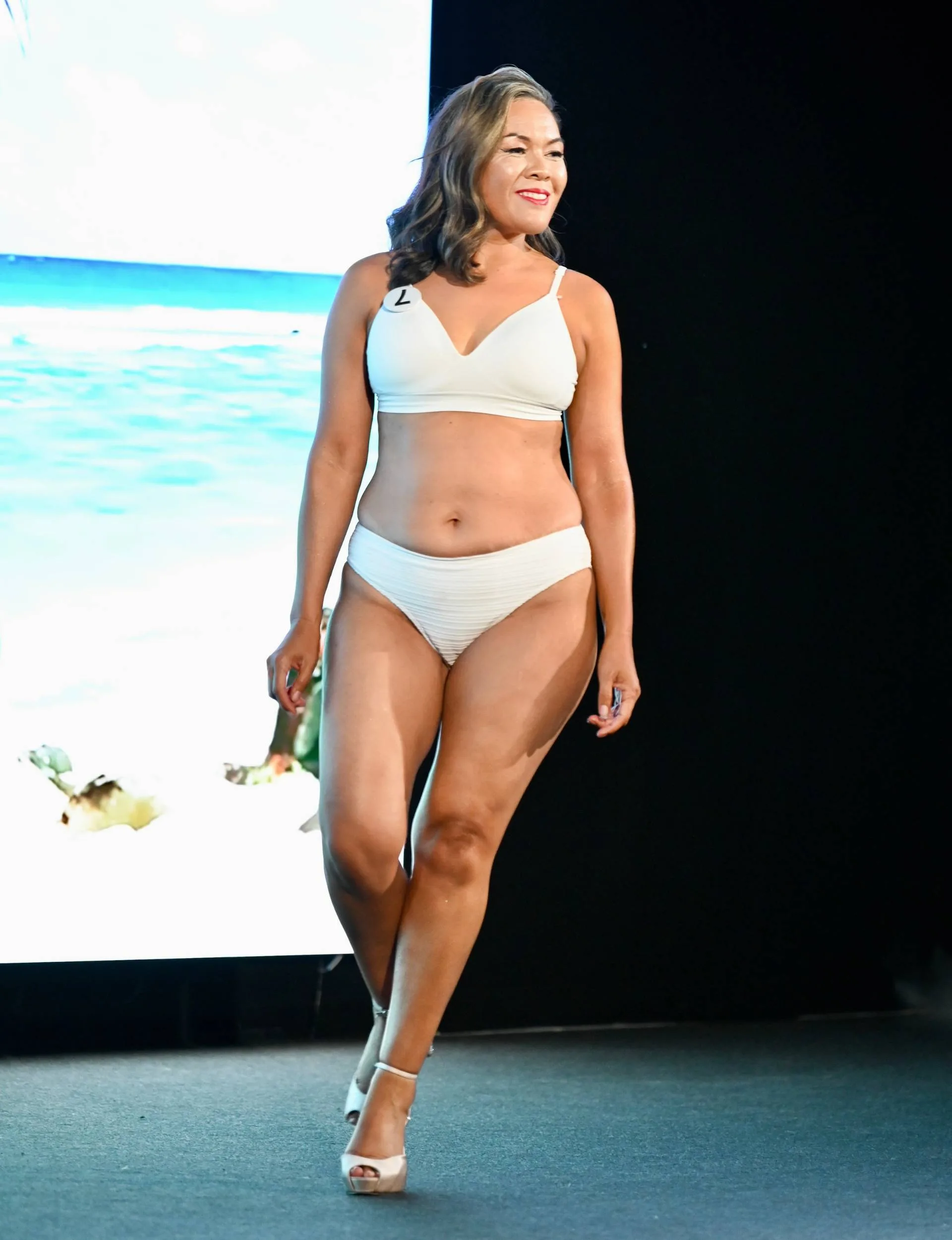 Delilah walking across the stage in the Bikini round