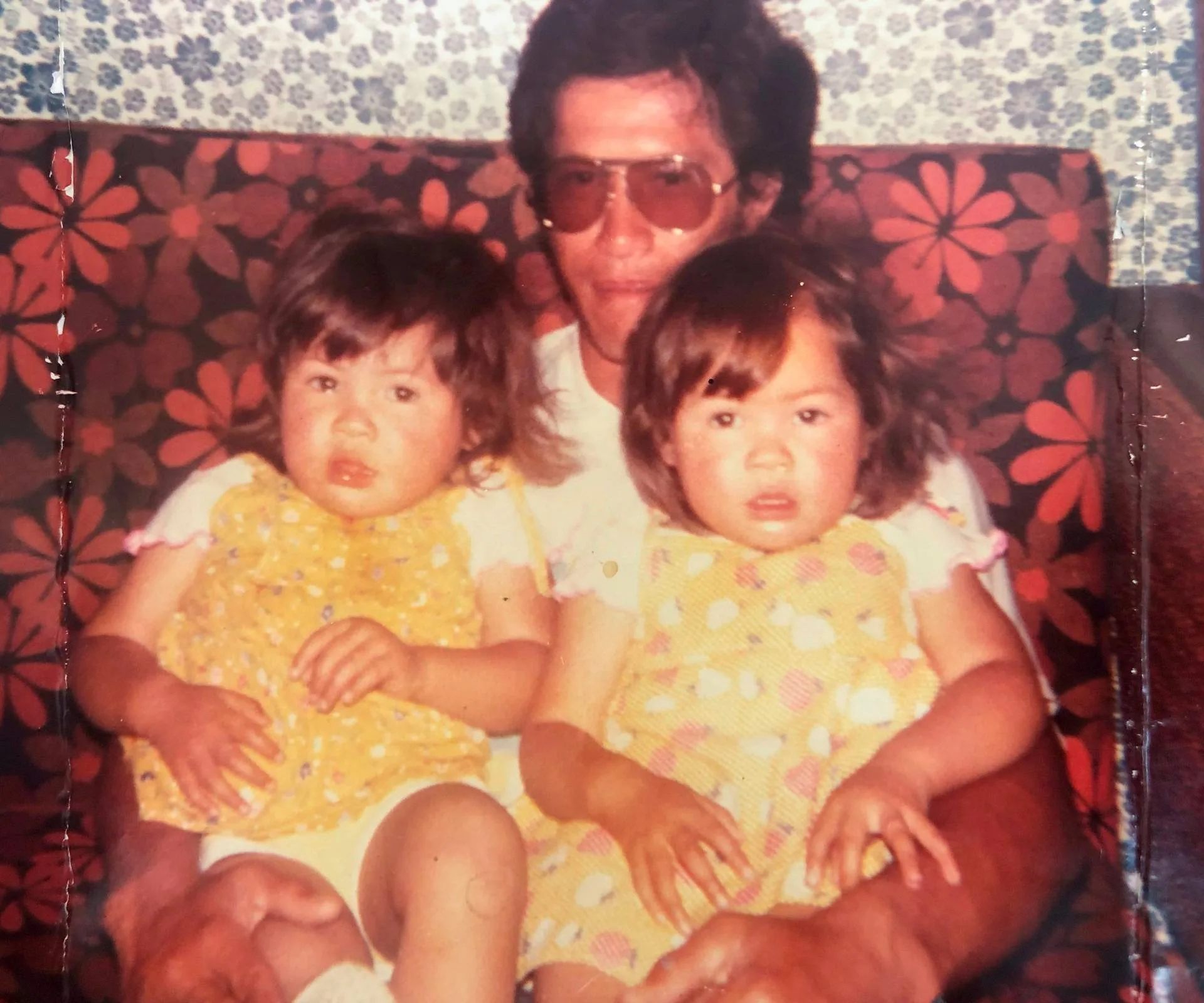 Delilah and her twin sister Tania Whaitiri on their dad's lap as toddlers