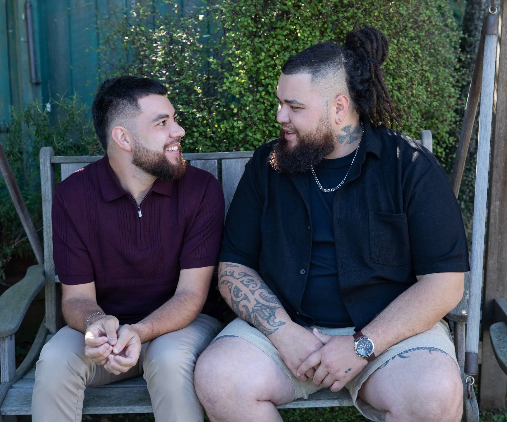 Te Ramanui Marriner on an outdoor chair with his twin brother