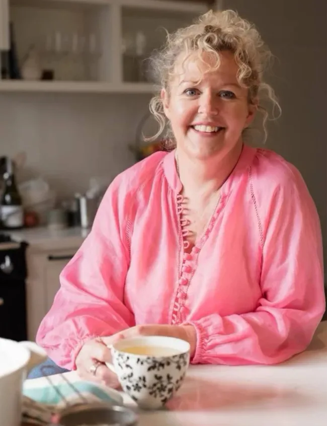 Cath Collins sitting at her table