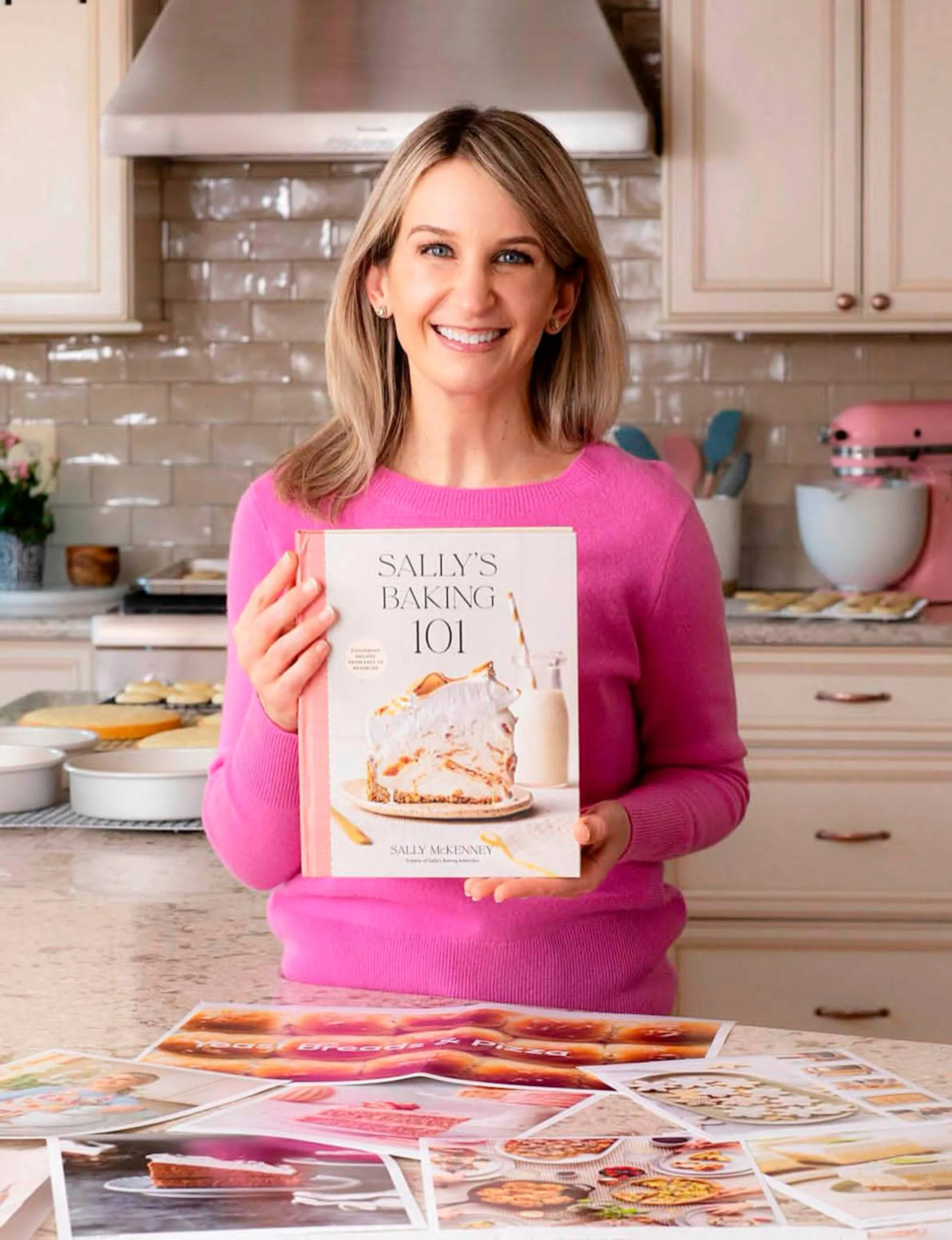 Sally McKenney holding her own cookbook