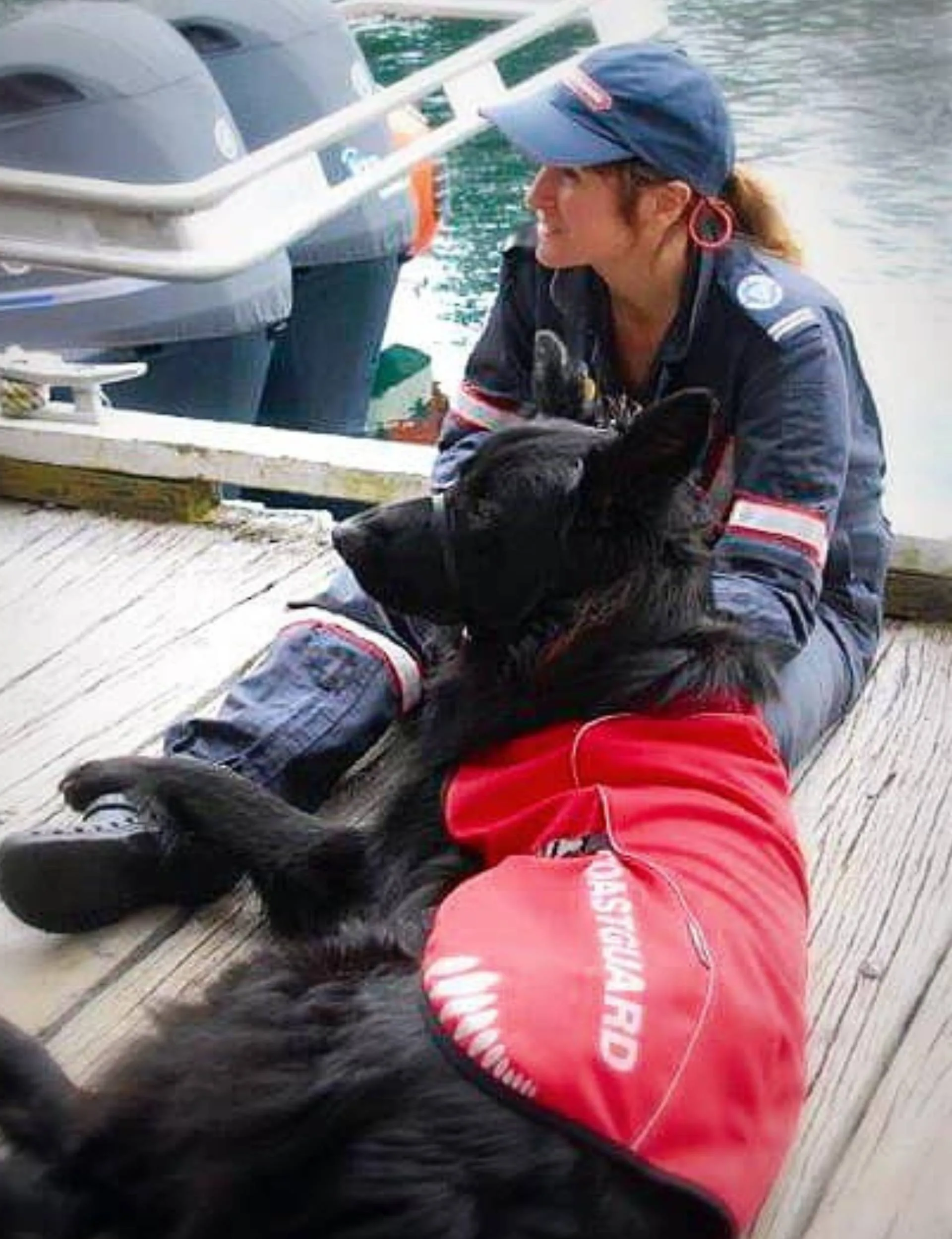 Alexandra Lattey sitting on a wharf with her dog