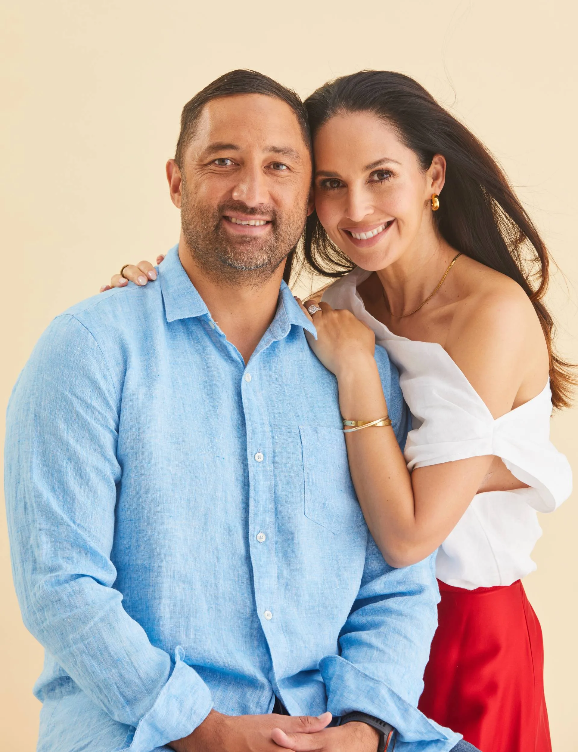 Benji and Zoe Marshall in front if a beige backdrop