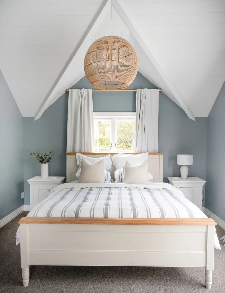 Coastal style bedroom in this Stillwater homestead