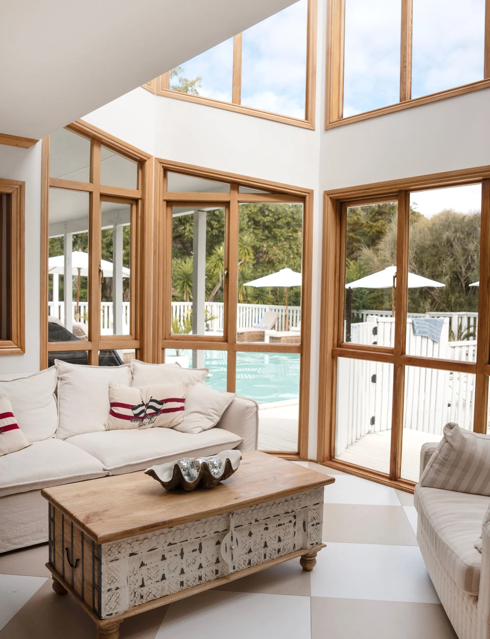 The expansive windows in the living room of this Stillwater homestead look out over the swimming pool