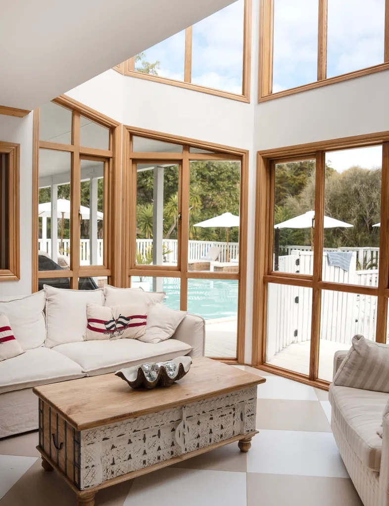 The expansive windows in the living room of this Stillwater homestead look out over the swimming pool