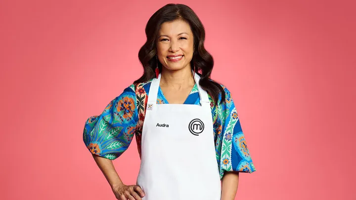 MasterChef contestant Audra Morrice in front of a red wall