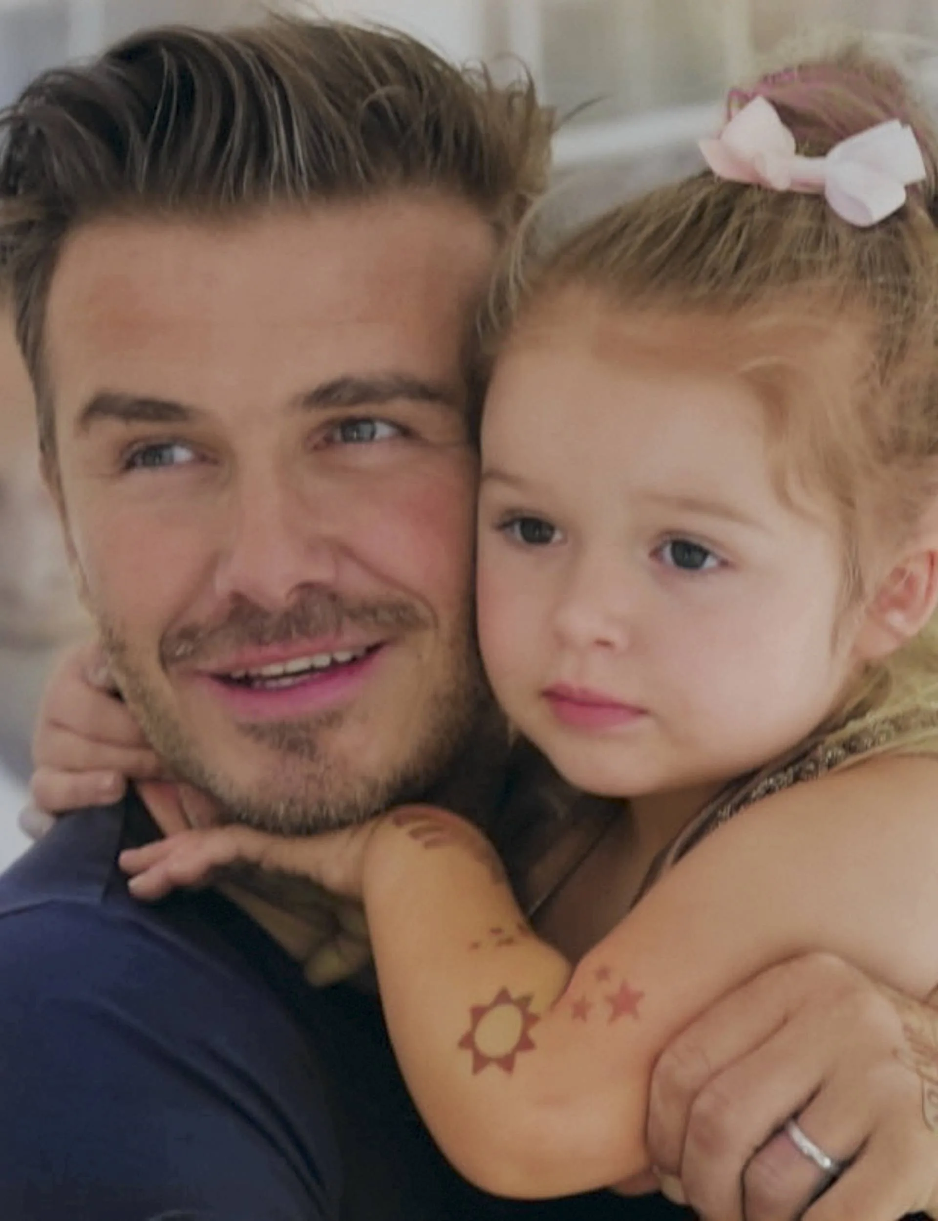 David Beckham holding his daughter, Harper