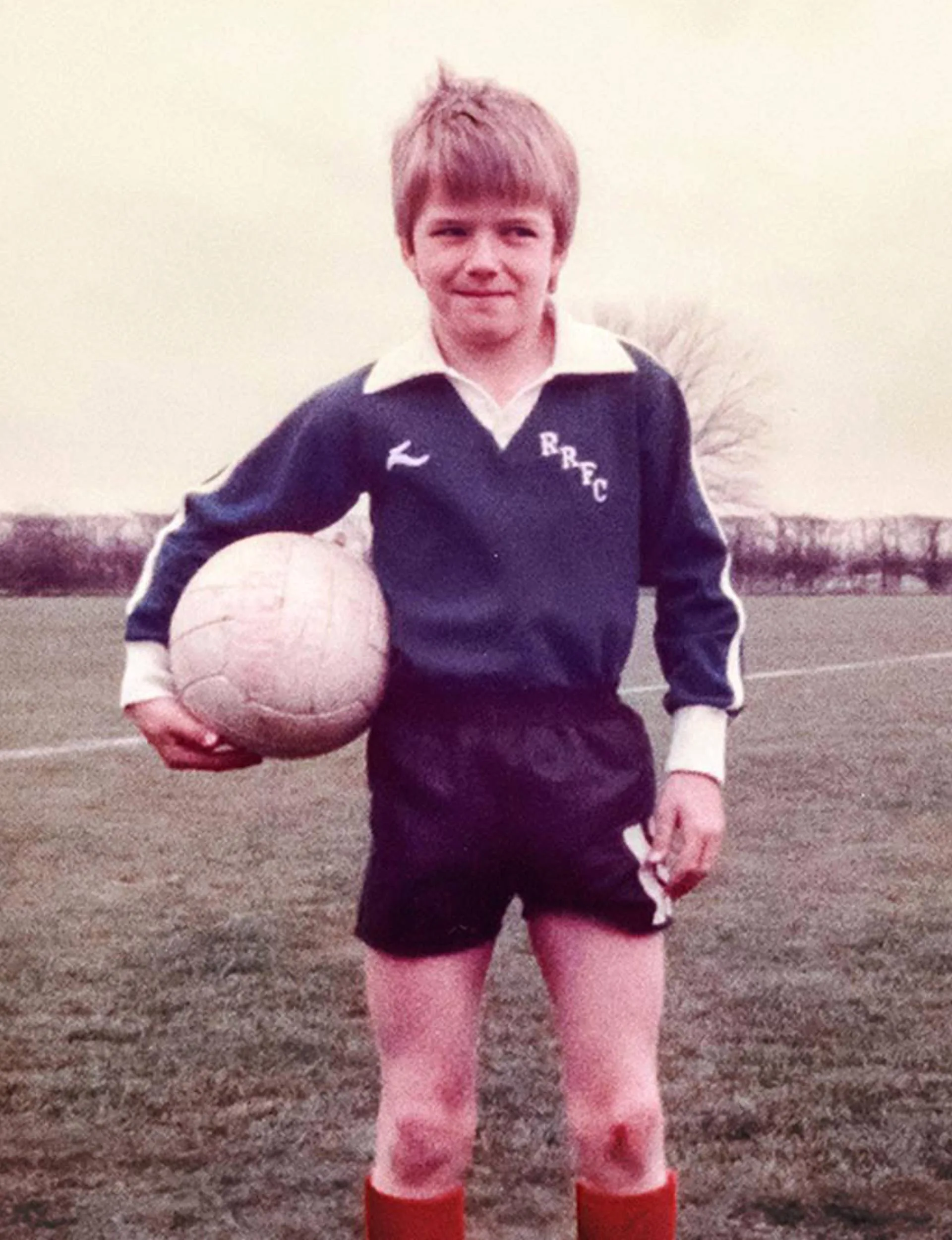 David with a ball on the field as a kid