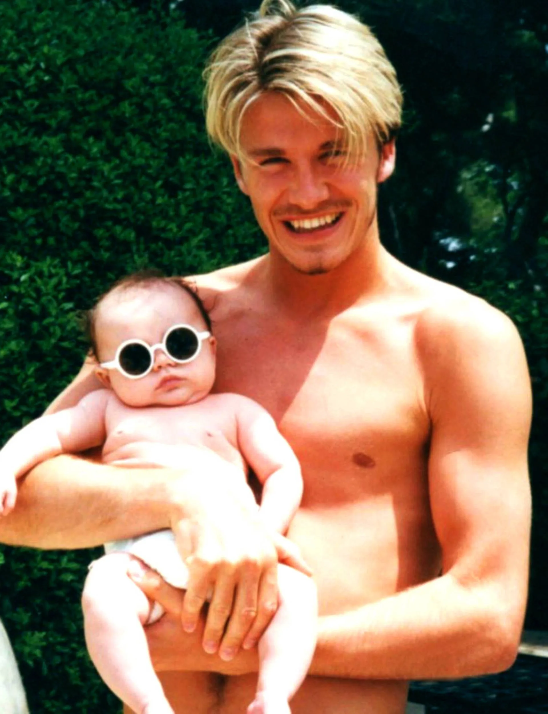 David Beckham holding his first-born, baby Brooklyn
