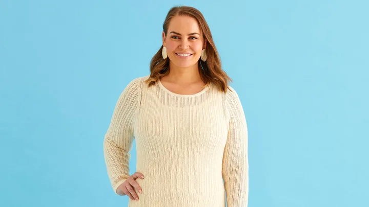 Jelena Dokic smiling with her hand on her hip