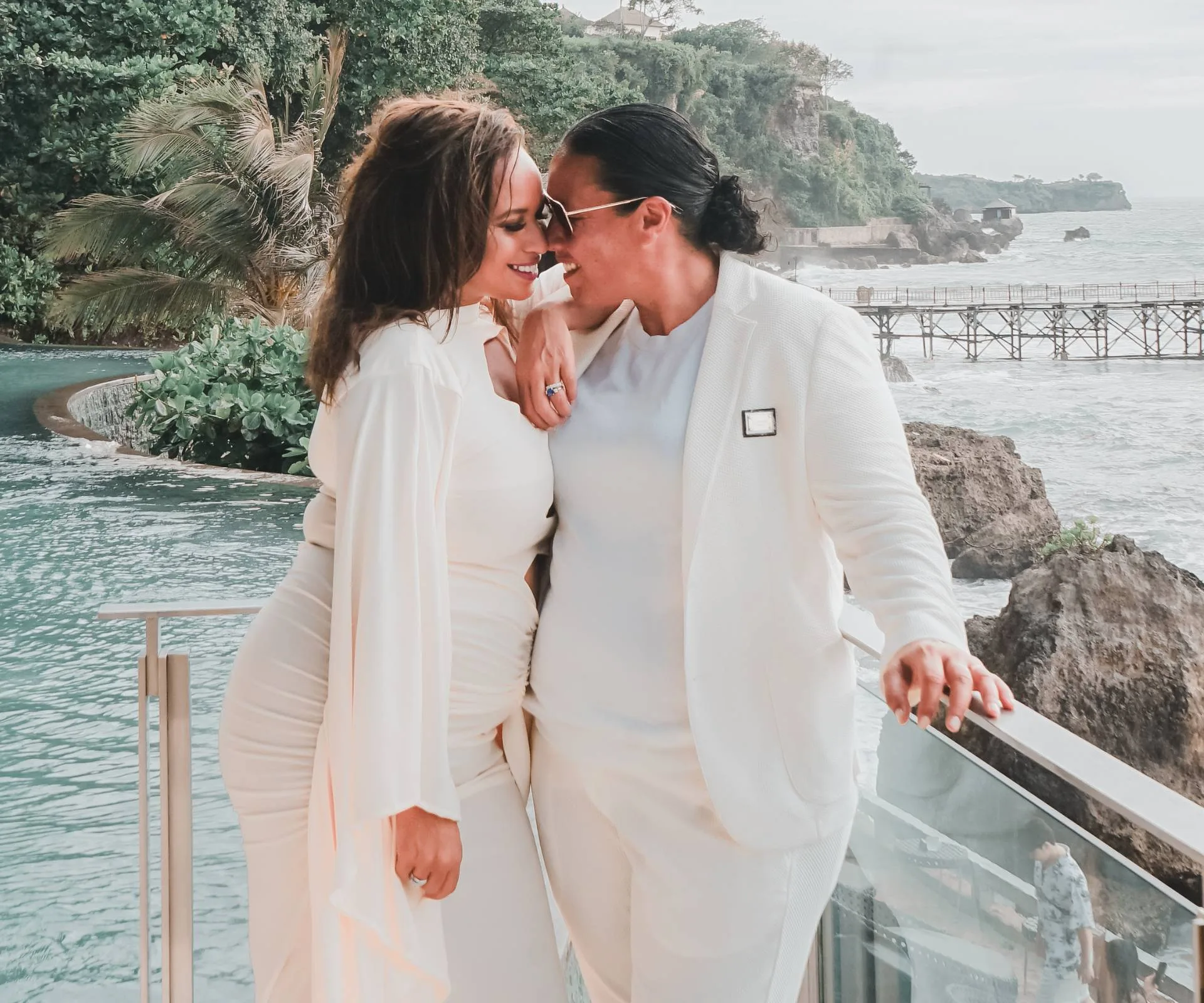 Megan Alatini and her bride Nat snuggling on their honeymoon