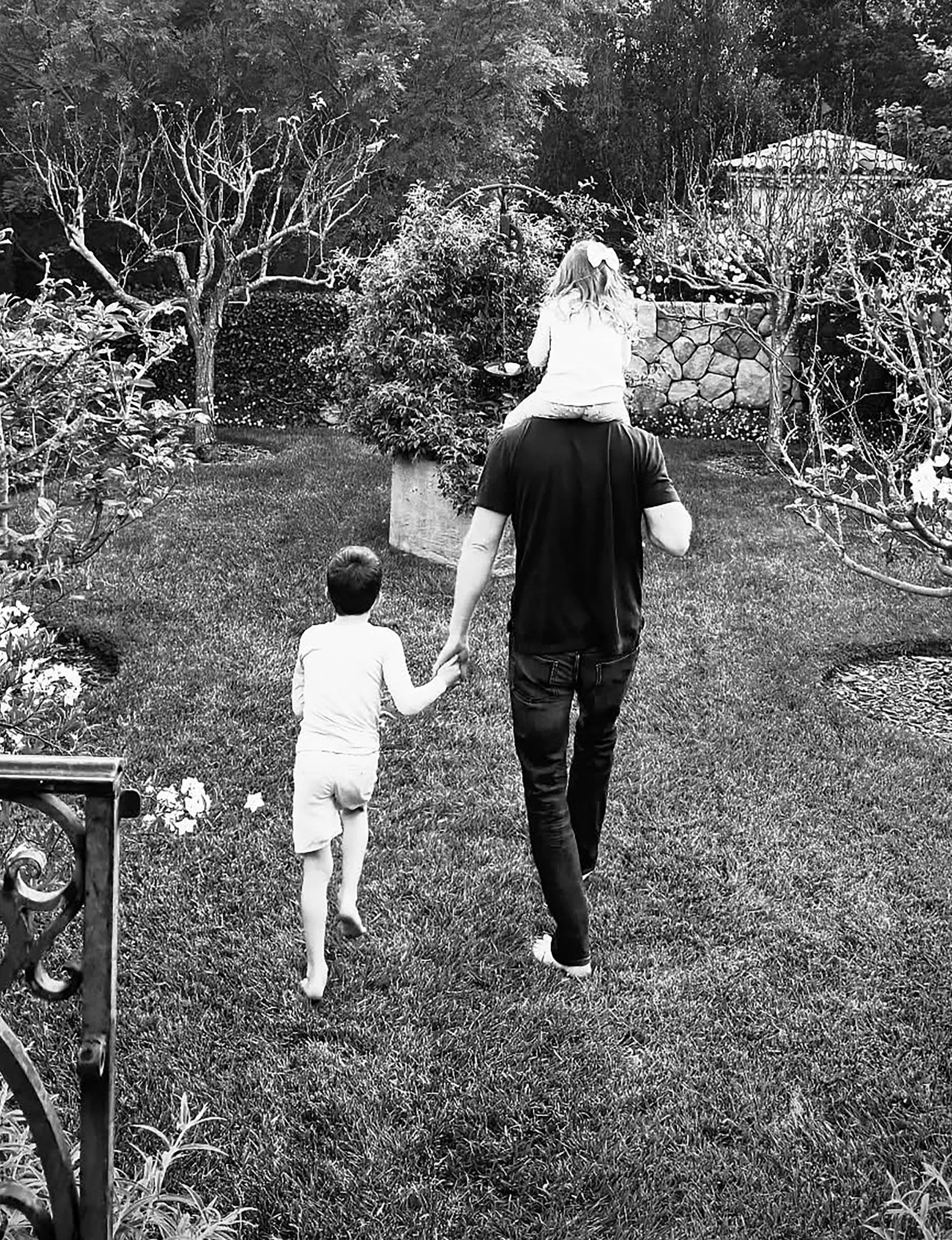 Prince Harry n a back yard with his children