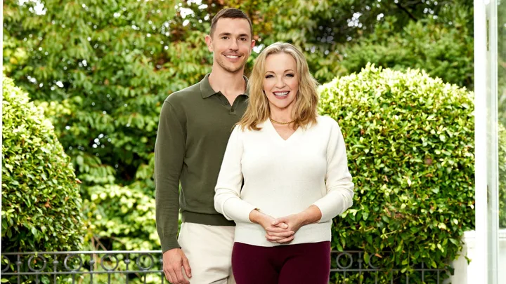 Rebecca and Harry smiling in front of some bushes