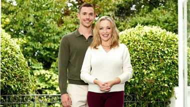 Rebecca and Harry smiling in front of some bushes