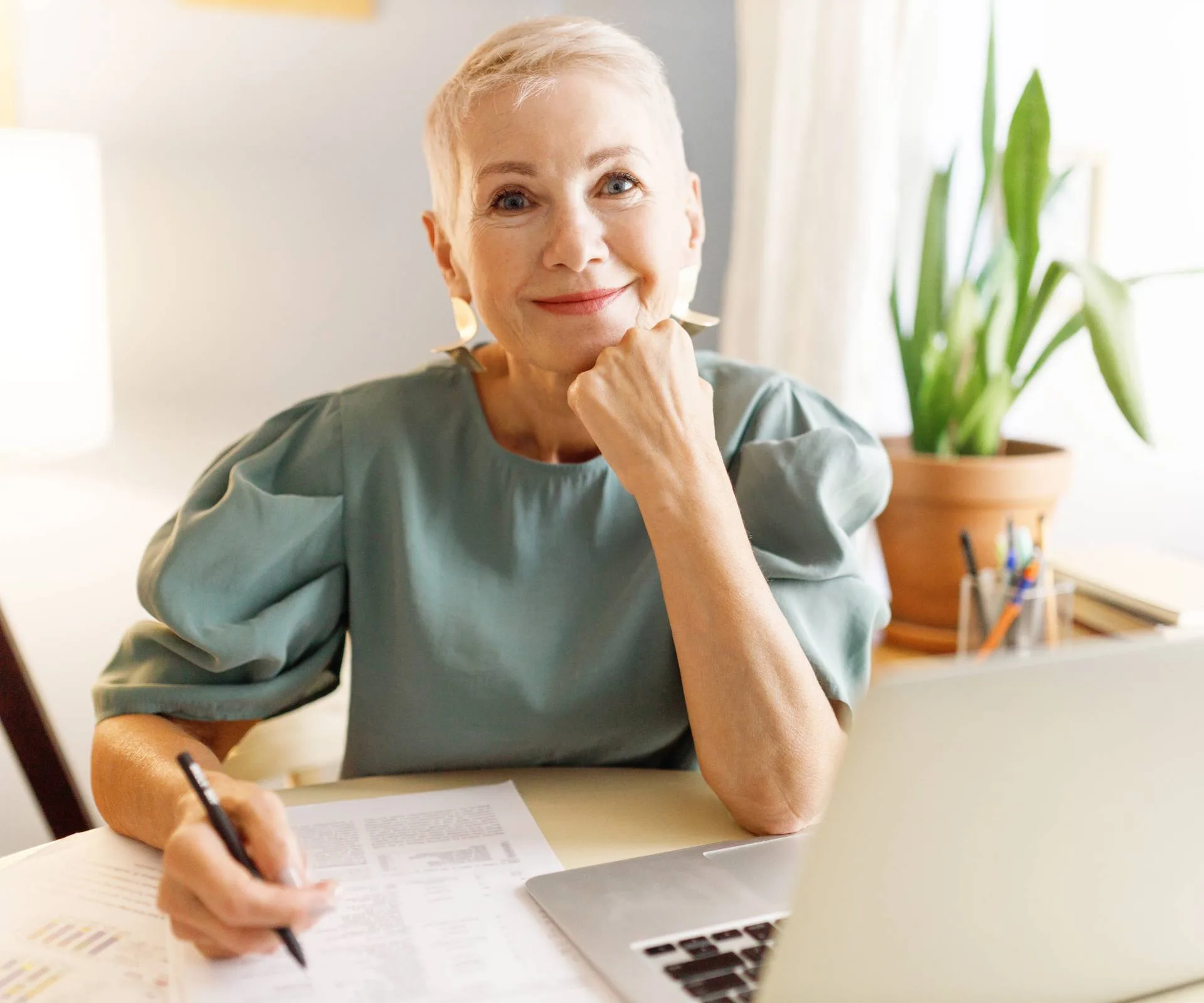 A woman over 50 working on a piece of paper