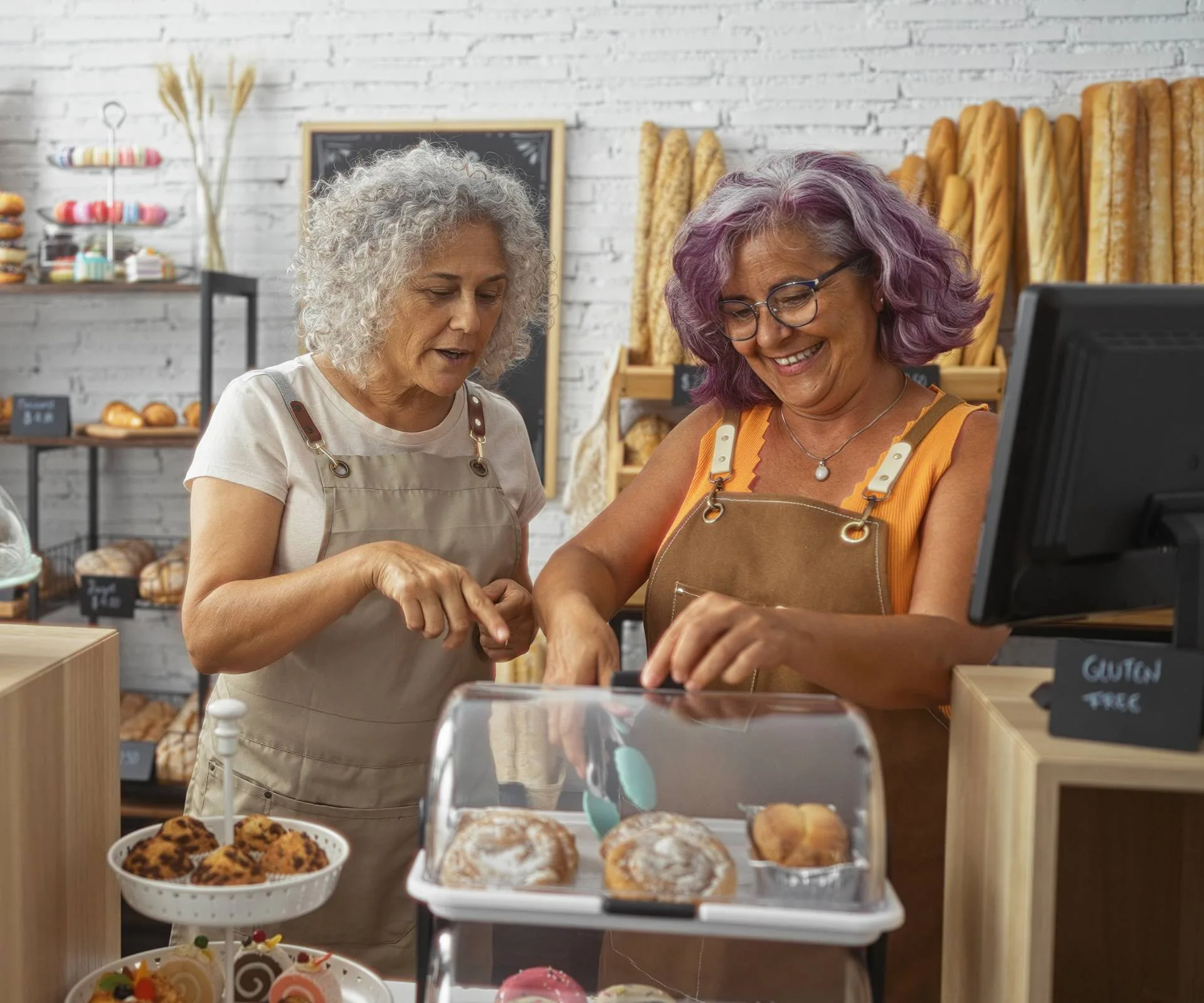 Two women over 50 at work in a bakery