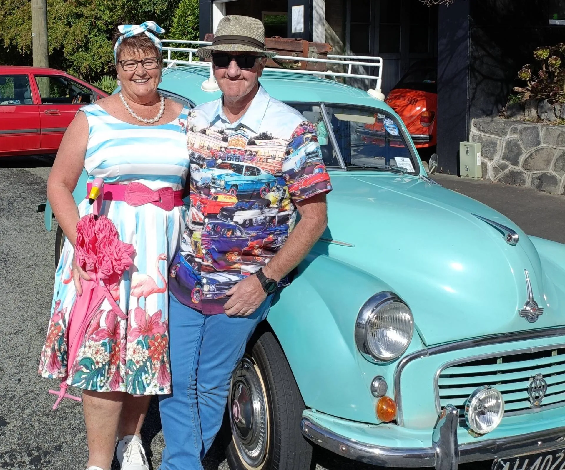 Anita and Brett leaning against the side of their Morris Minor