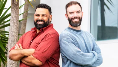 Between Two Beers podcast hosts standing back to back