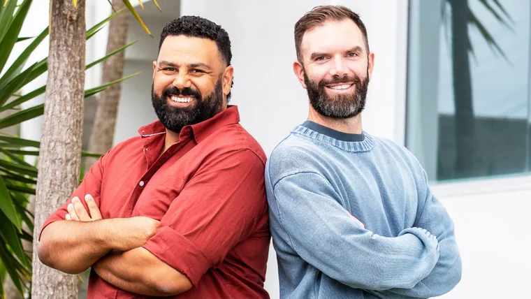 Between Two Beers podcast hosts standing back to back