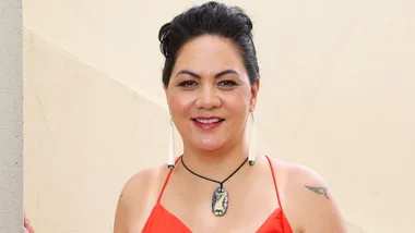 Rangi-Arahina Renee Daniels smiling in a red dress