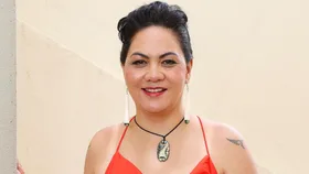 Rangi-Arahina Renee Daniels smiling in a red dress