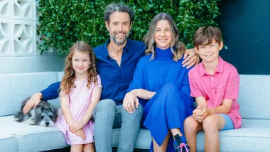 Jon Bridges with his wife, puppy and kids on an outdoor couch