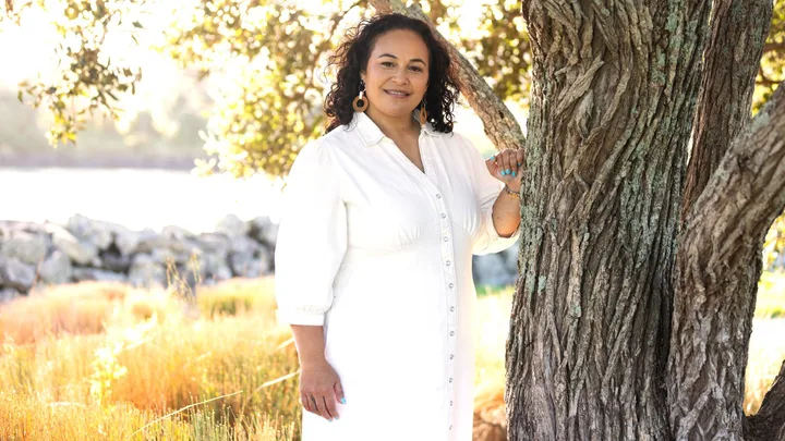 Reena Jefferson standing beside a tree