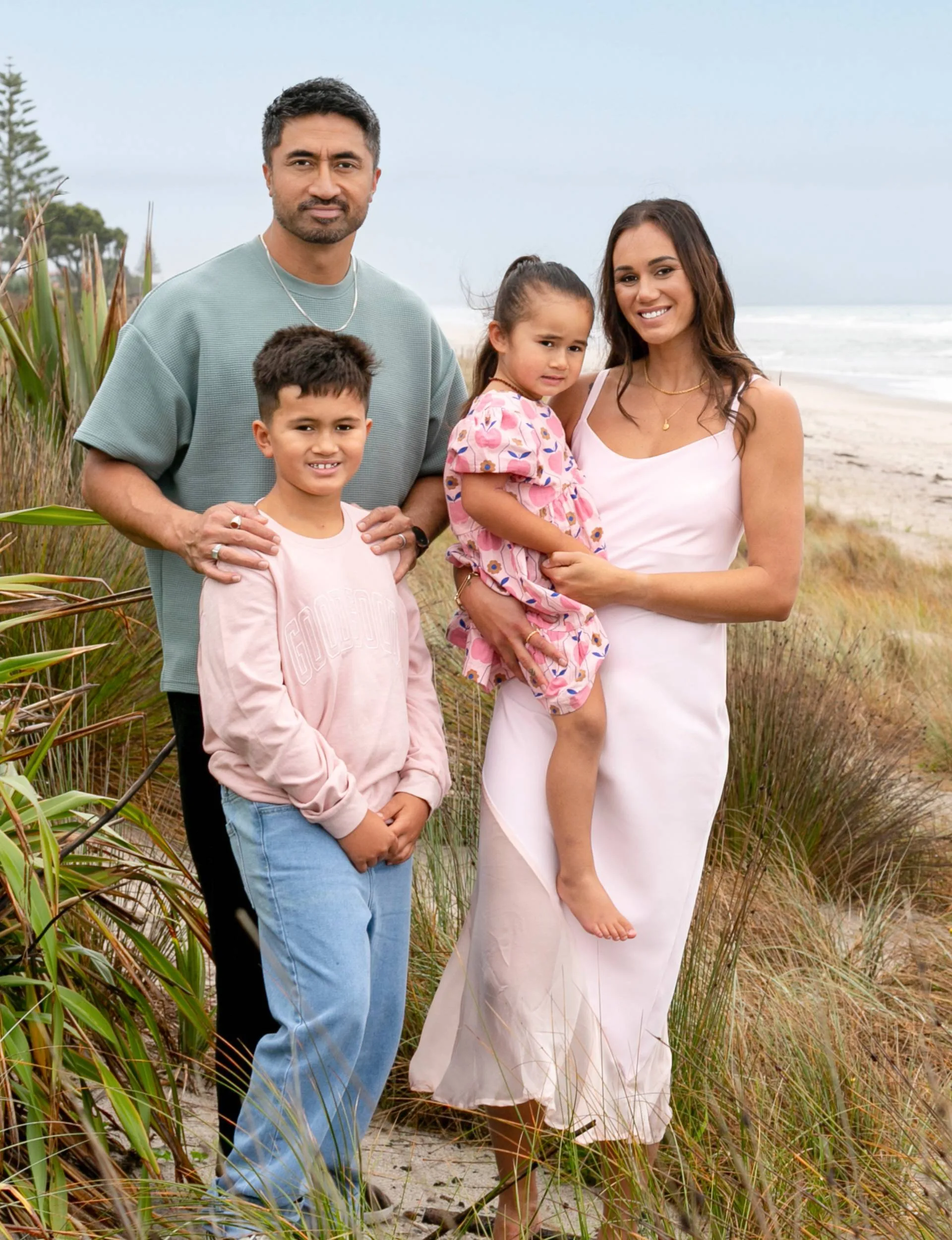 Ameliaranne with her husband and kids on a beach
