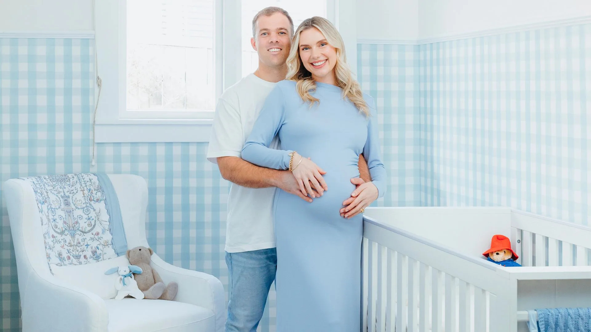Caitlin Crisp in her blue nursery with her husband