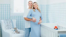 Caitlin Crisp in her blue nursery with her husband