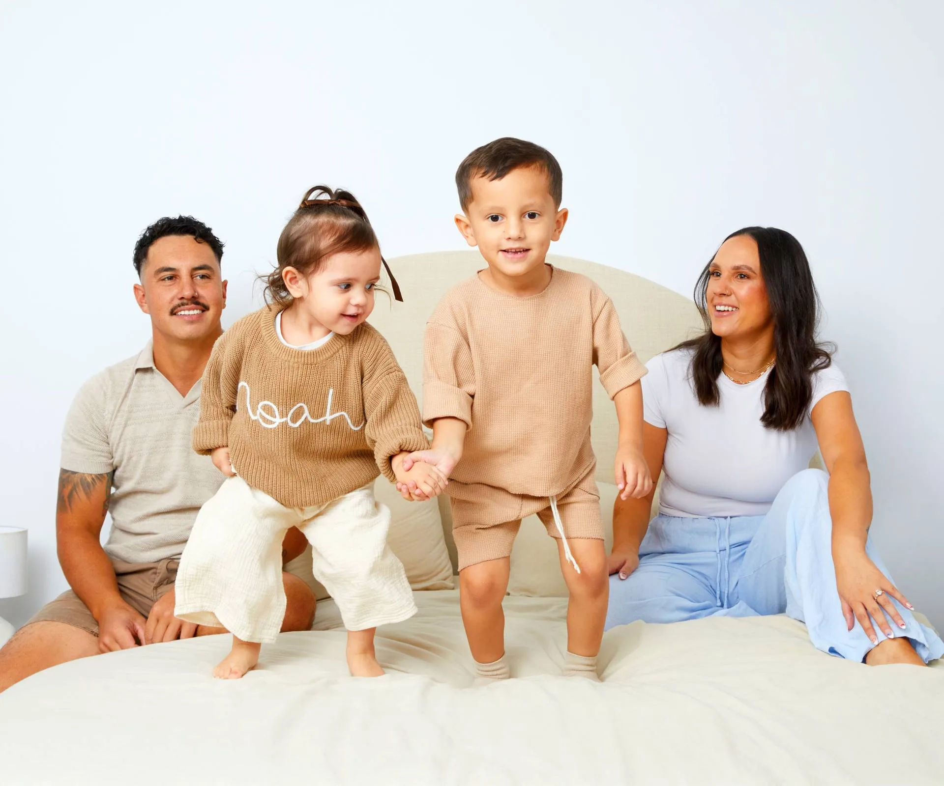 Ethan Ordish with fiancee Mia while the kids jump on the bed with them