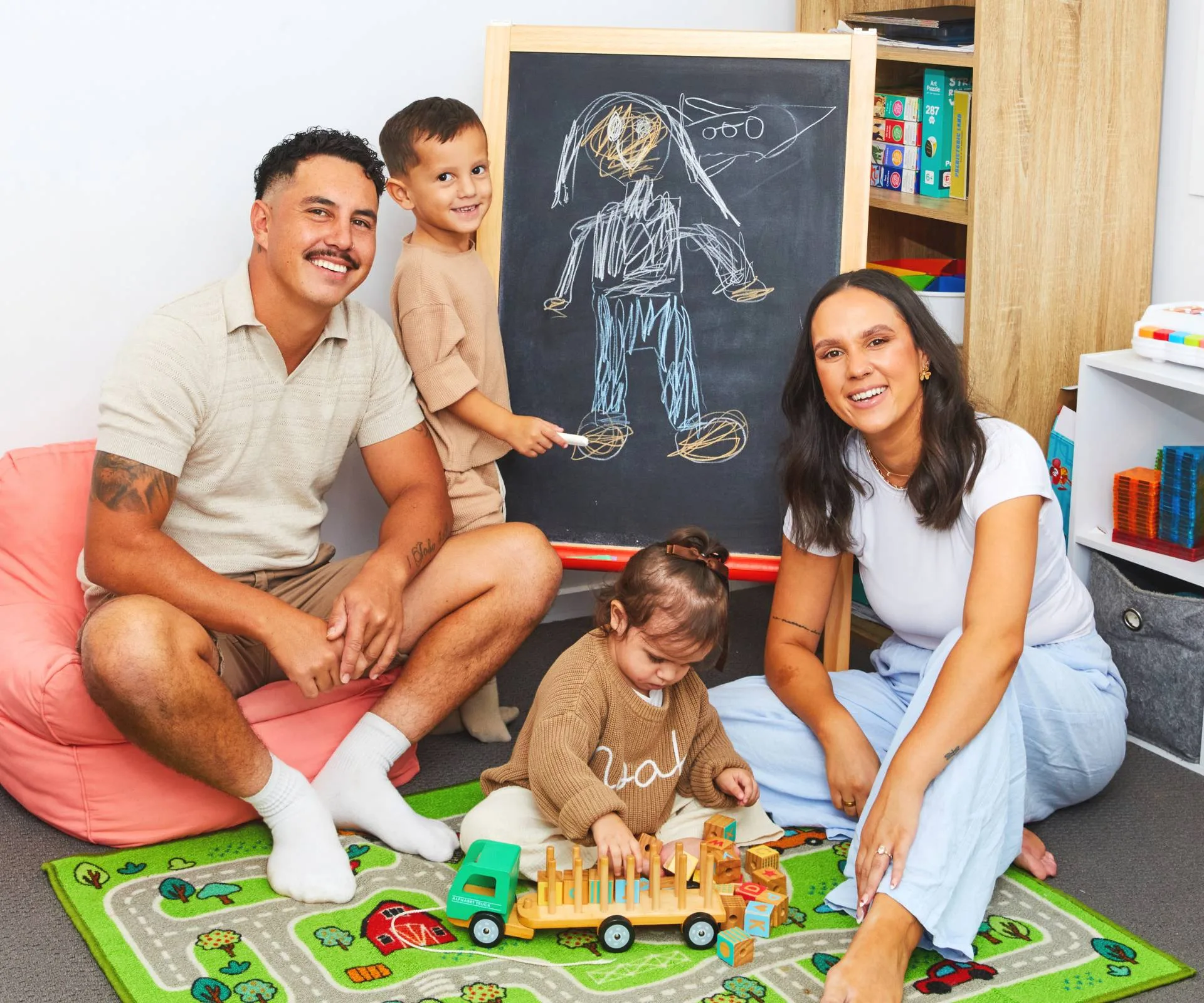 Ethan Ordish with fiancee Mia and their kids playing on the ground