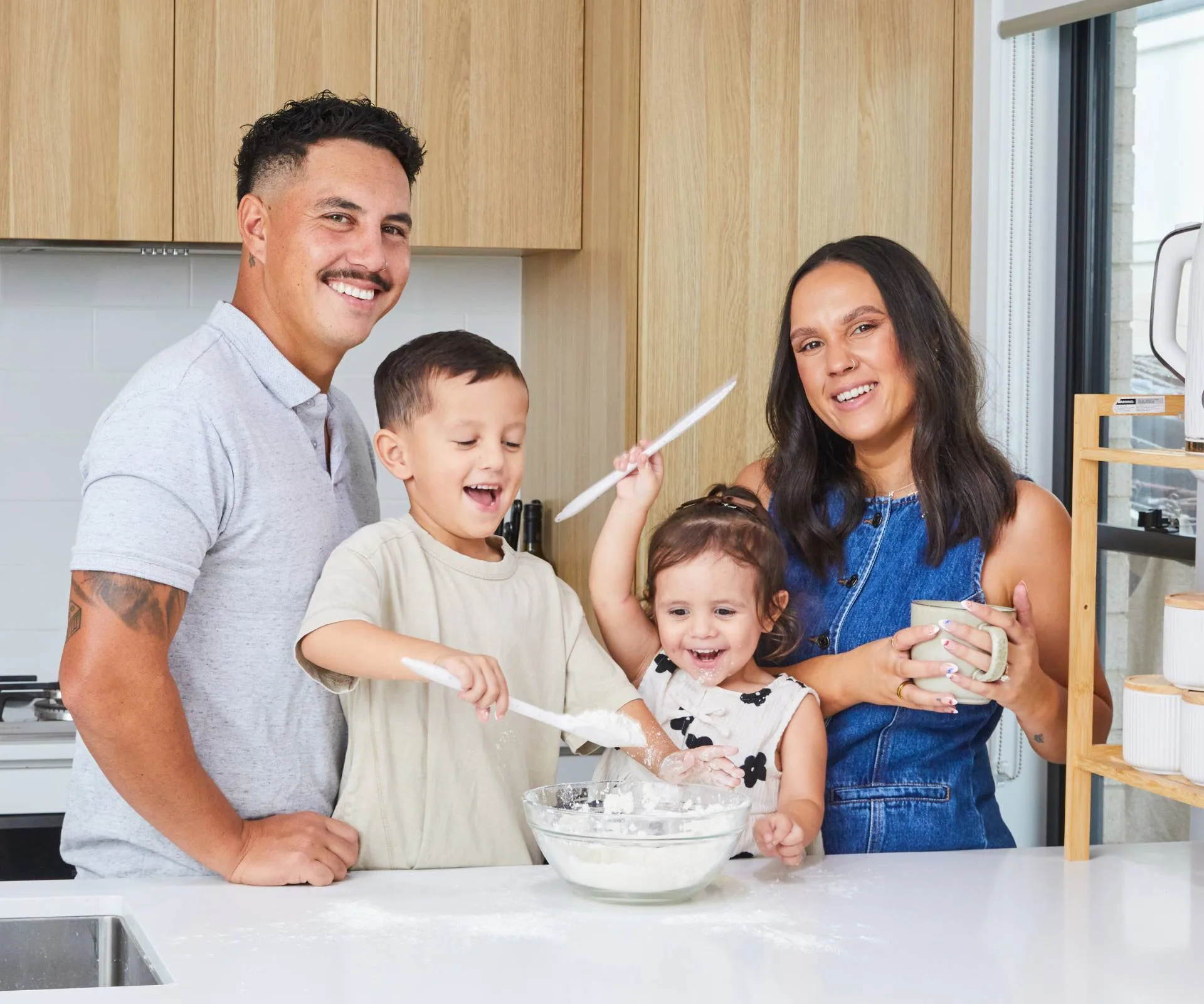 Ethan Ordish with his fiancee and kids in the kitchen while his kids make a mess