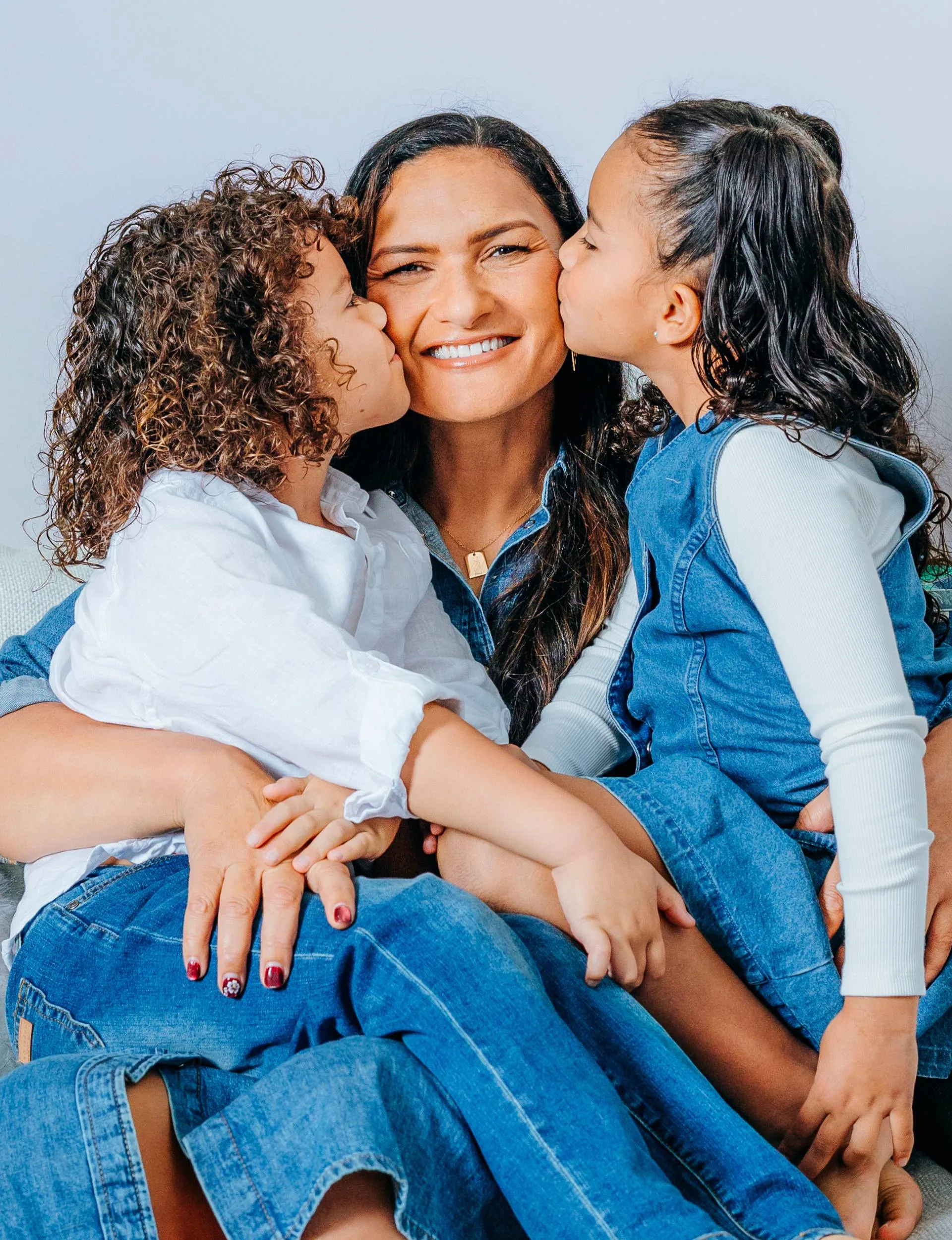 Dame Val with her kids on her lap