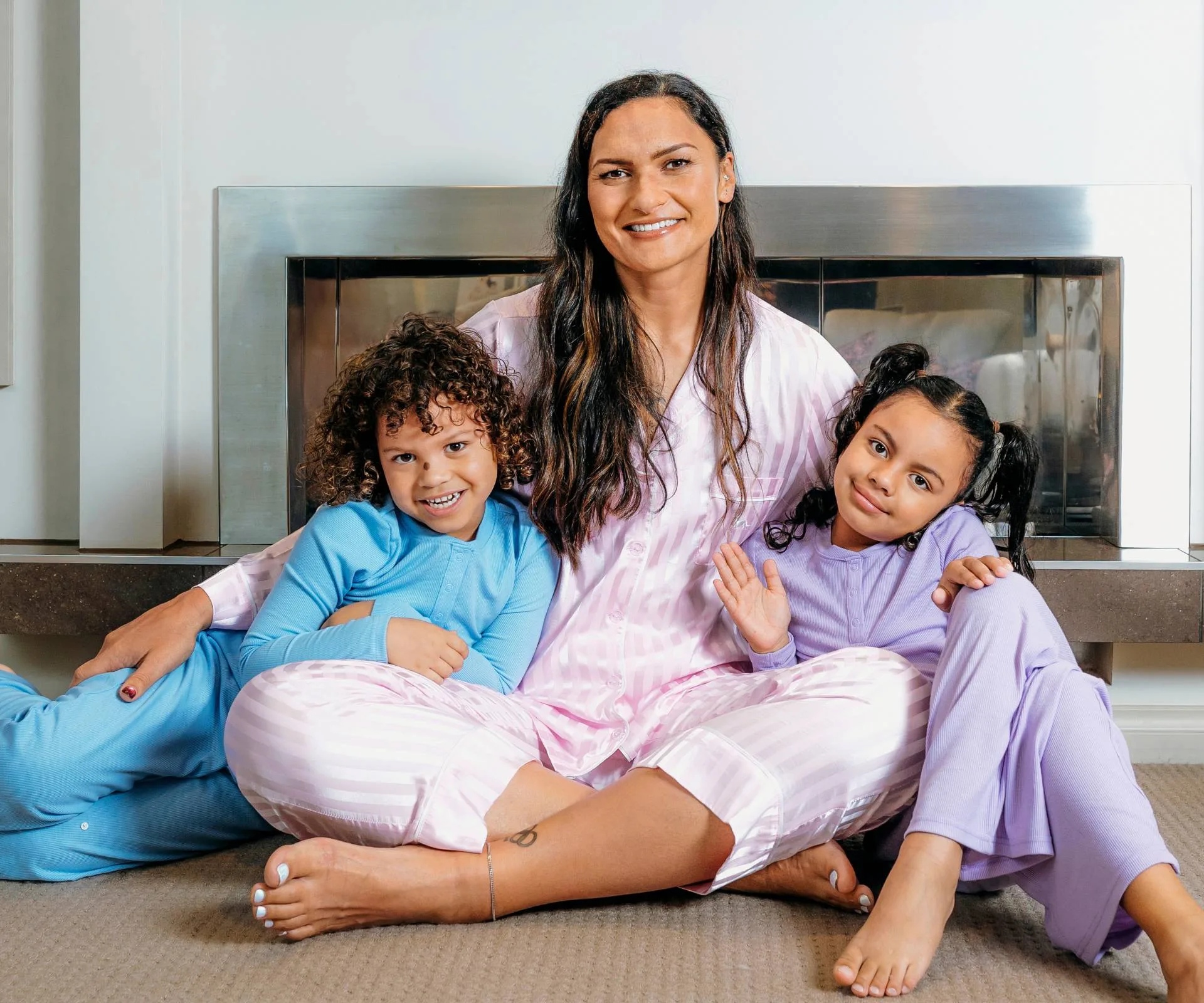 Valerie with Tava and Kimoana in their Jammies For June pyjamas in front of their fireplace