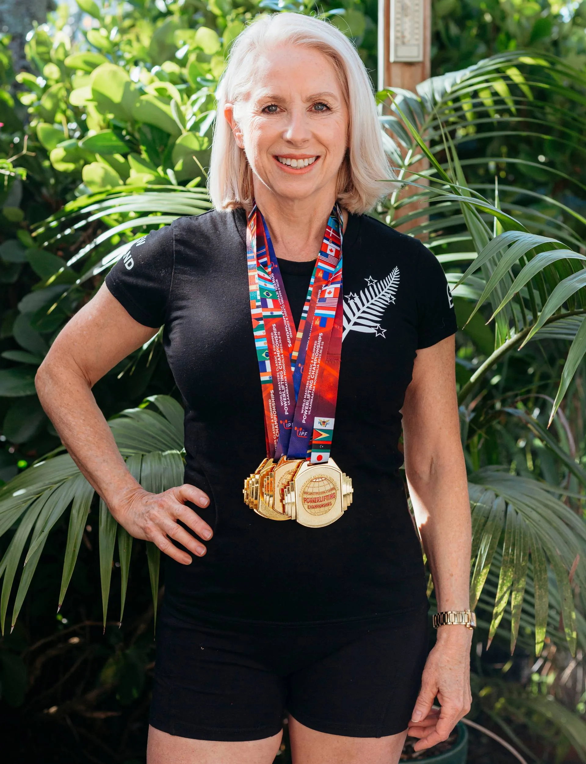 Julianne Taylor wearing her powerlifting medals