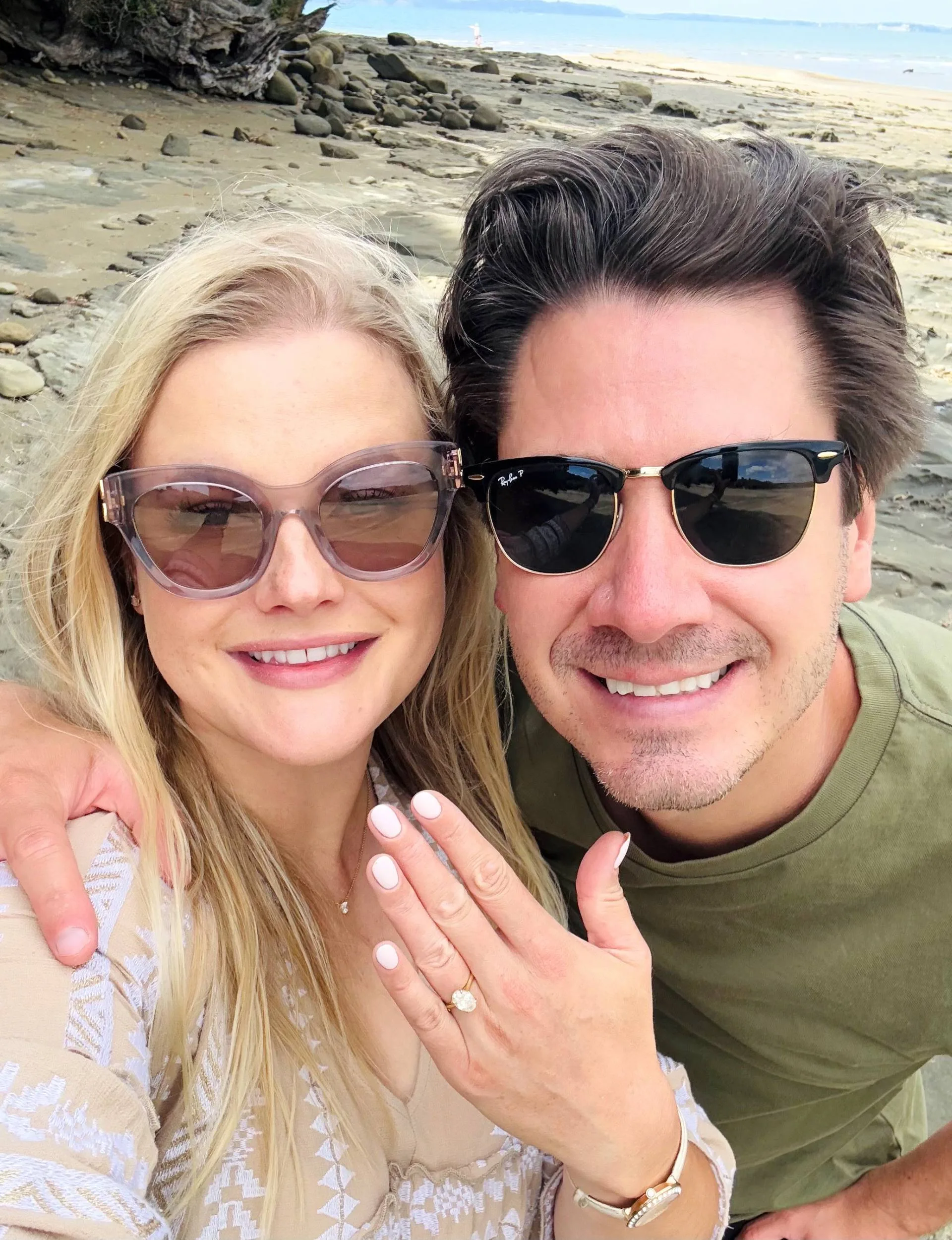 Sophie and brad on the beach after the proposal