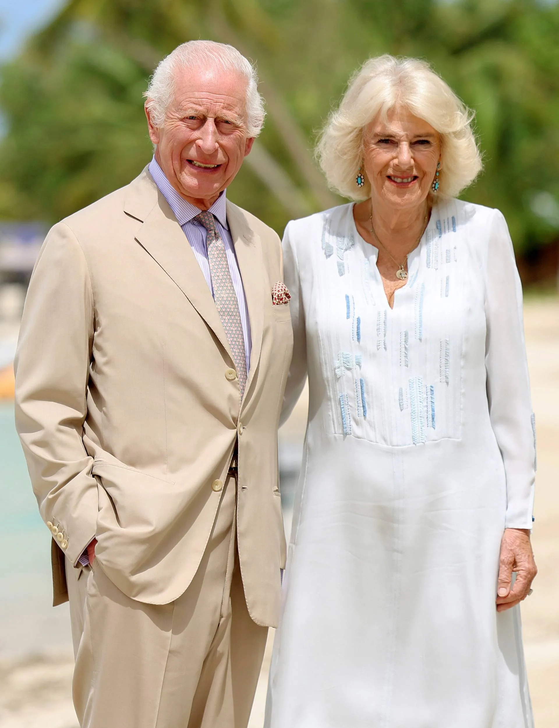 King Charles with Camilla on a beach