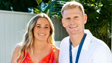 Finn Butcher wearing his Paris Olympics gold medal with his girlfriend Courtney beside him