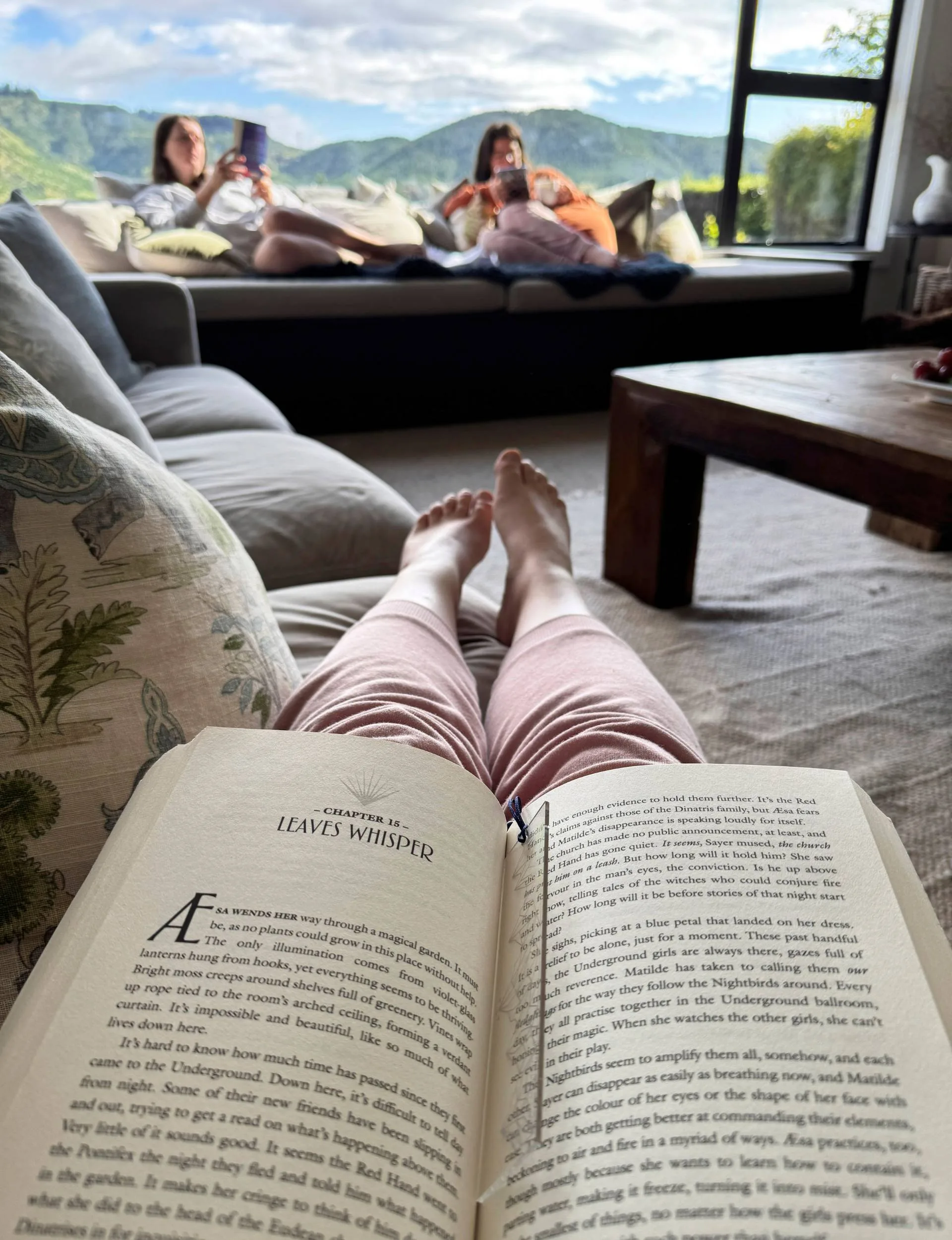 Hanna Rauch's feet behind the pages of a book at a retreat