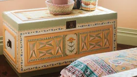 A sunset coloured blanket chest inspired by folk art