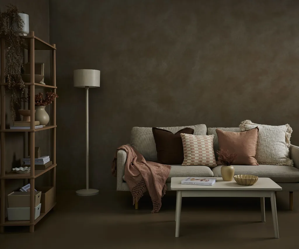 A textured low-sheen finish creates a suede-like effect that is both cosy and elegant in living or retreat spaces. The dark tones are balanced with beige furniture pieces to create a calming staycation spot.