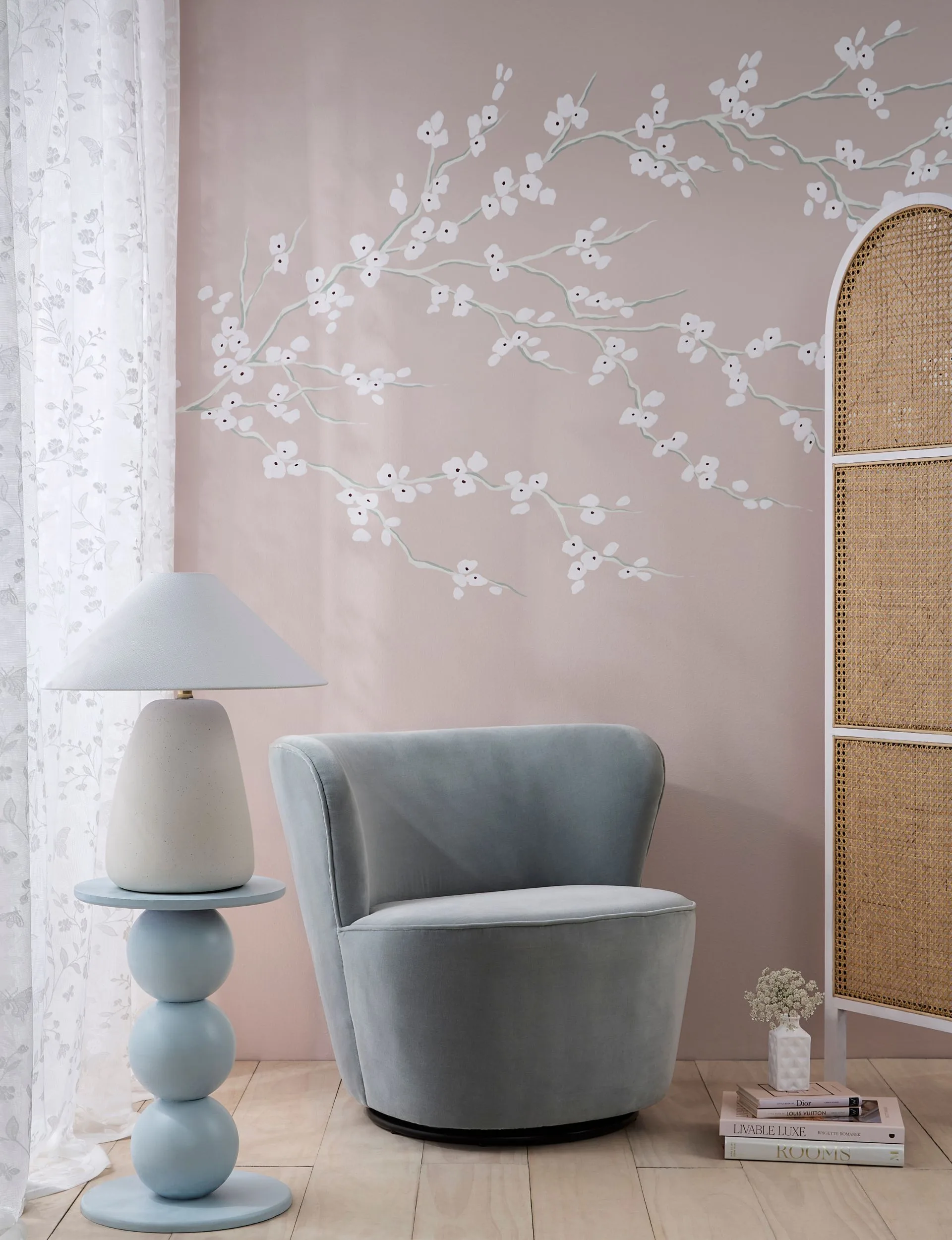 Blossom mural painted in delicate pastel pink and white, with luxurious chair creates an immediate hotel chic vibe