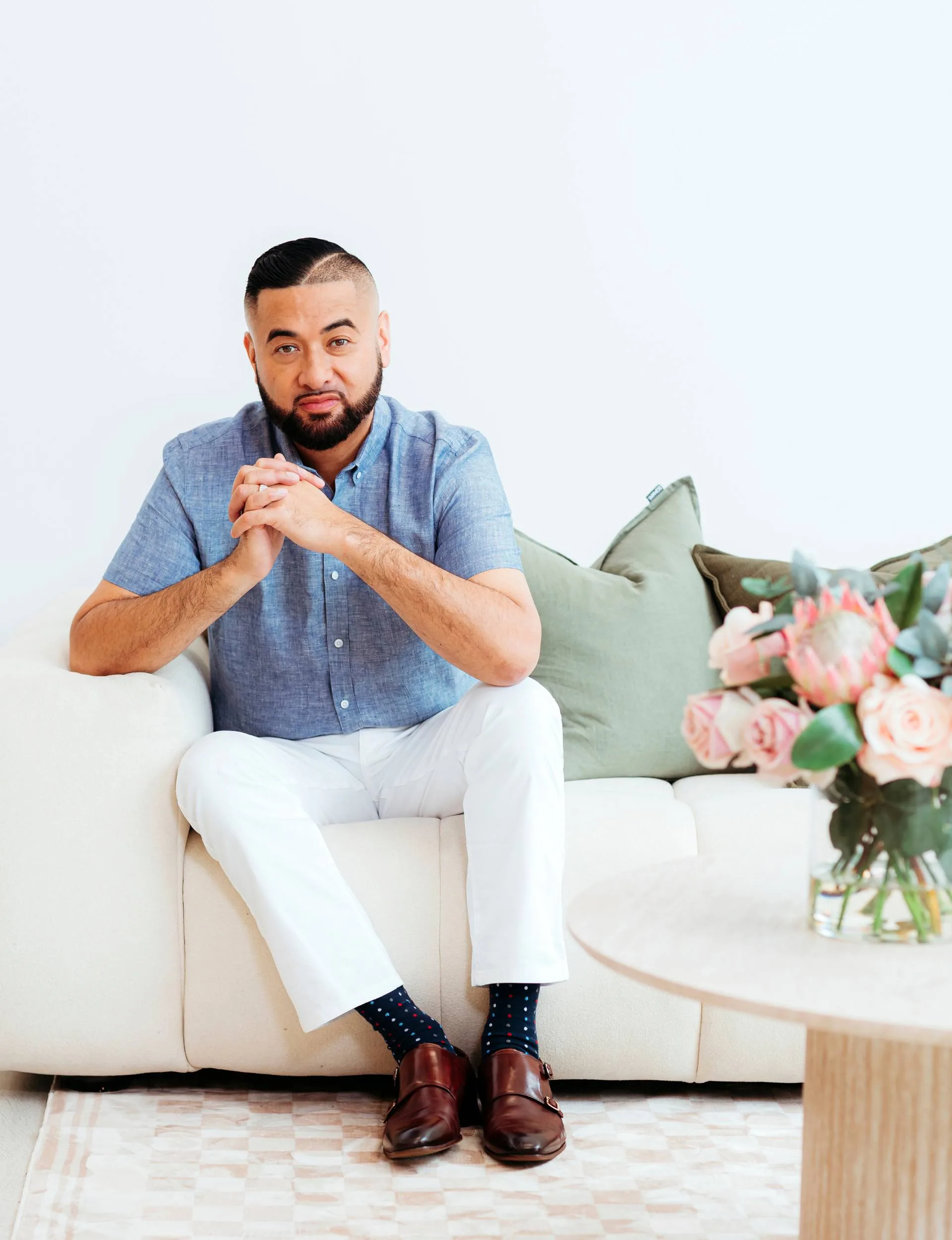 francis tipene sitting on couch
