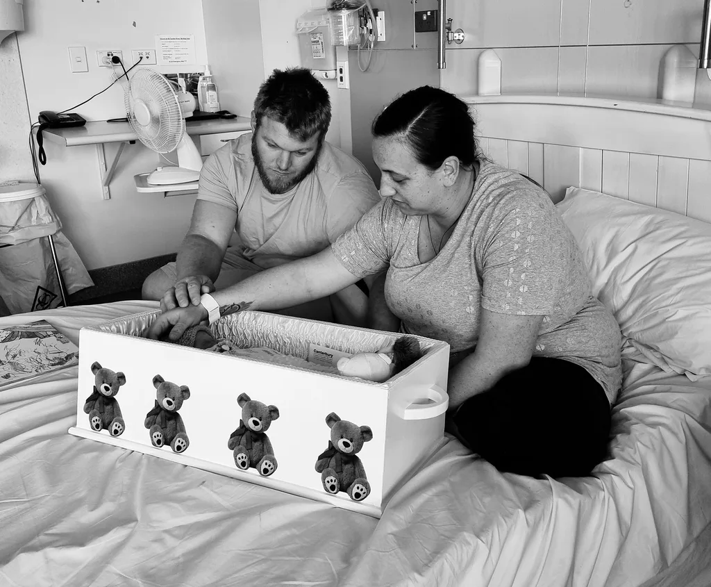 kylie and ben collins with baby in coffin