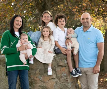 george and kayla whitlock standing with their five children