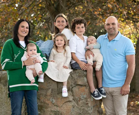george and kayla whitlock standing with their five children