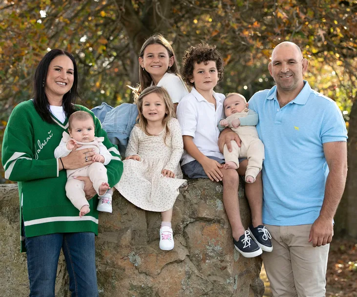 george and kayla whitlock standing with their five children